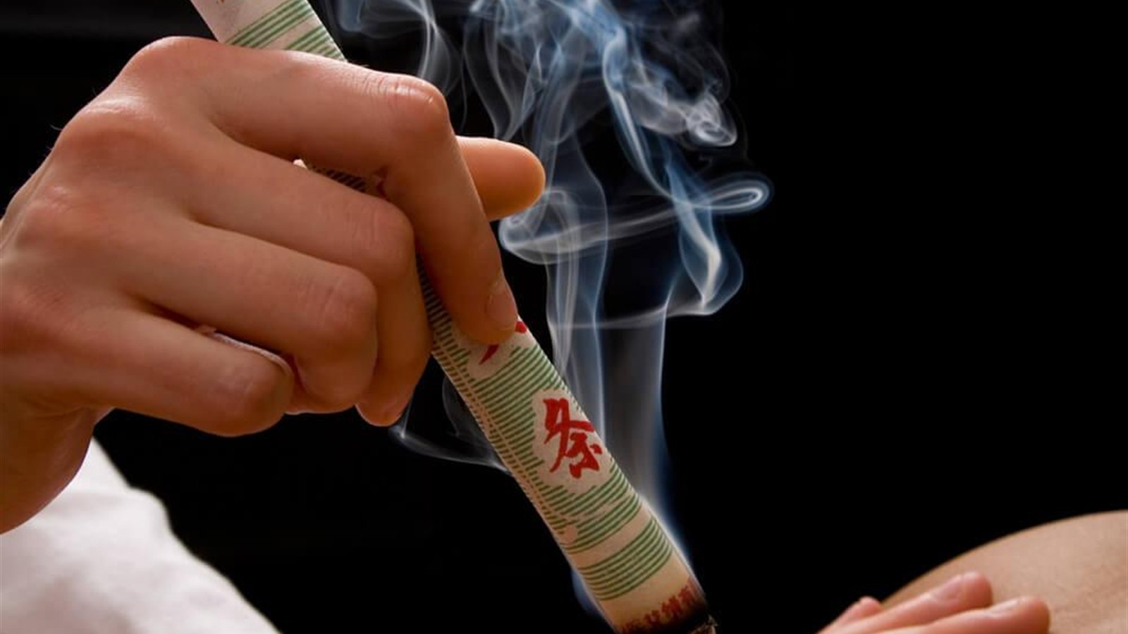 Handheld moxa stick used above the body for a traditional warmth ritual