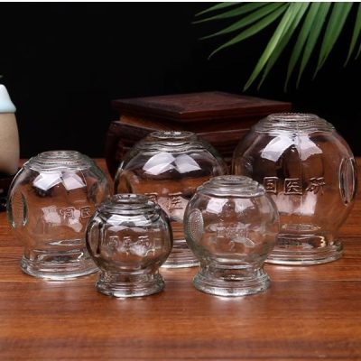 Thickened glass cupping jars on a wooden surface
