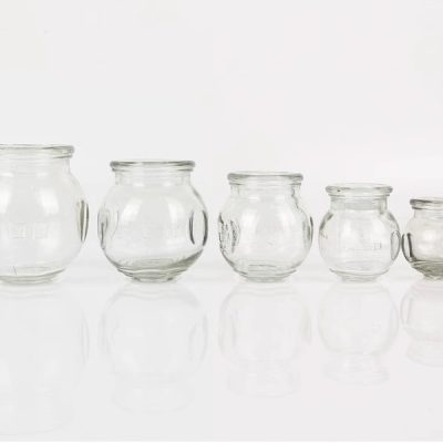 Five glass cupping jar size options on a clean background