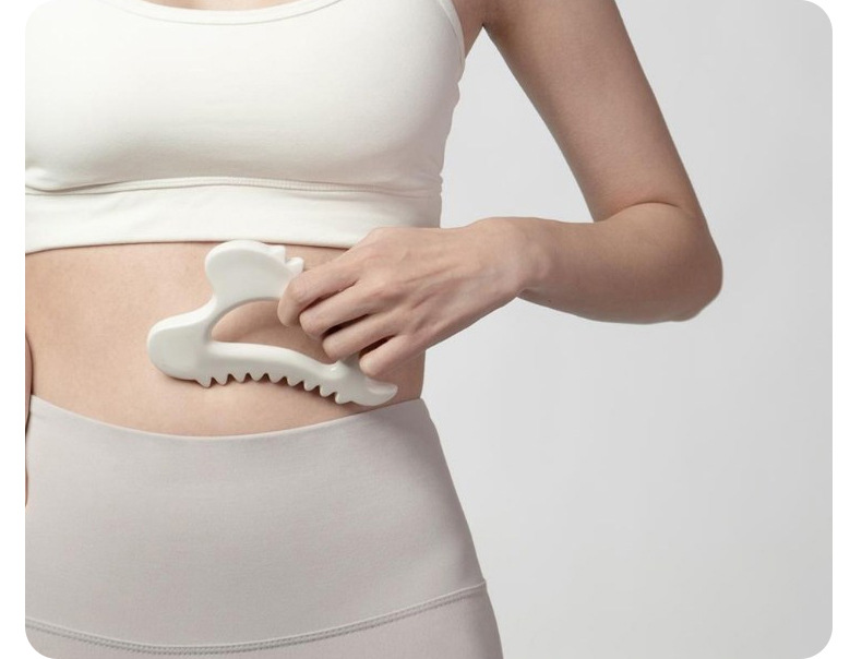 Ceramic Gua Sha massage tool in a body self-care routine