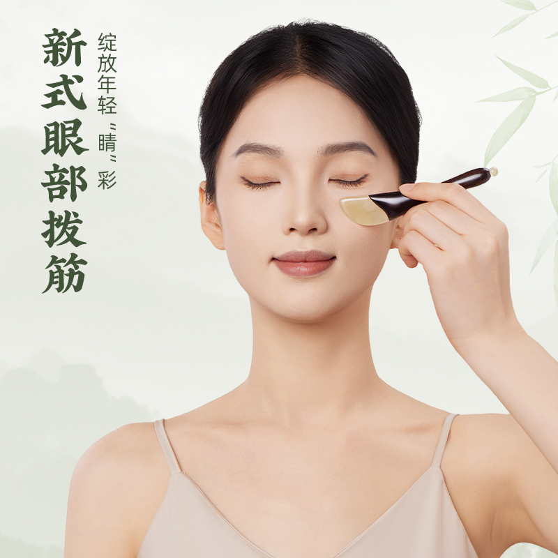 Ebony wood and natural horn eye Gua Sha tool in use