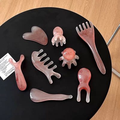 Pink resin gua sha massage tool set display